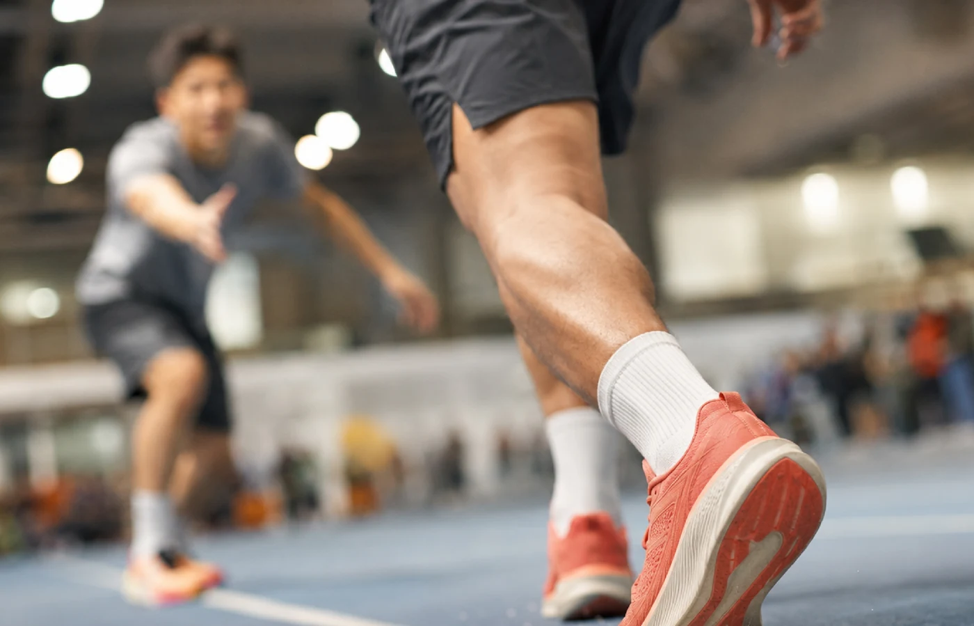 Athletes in motion on an indoor sports court