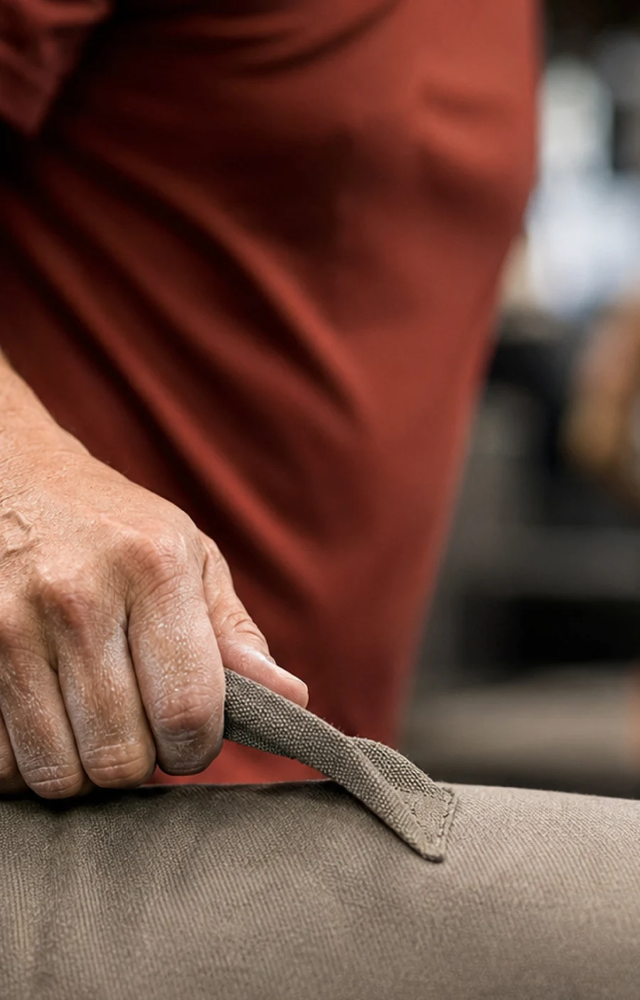 An athlete gripping a training sandbag